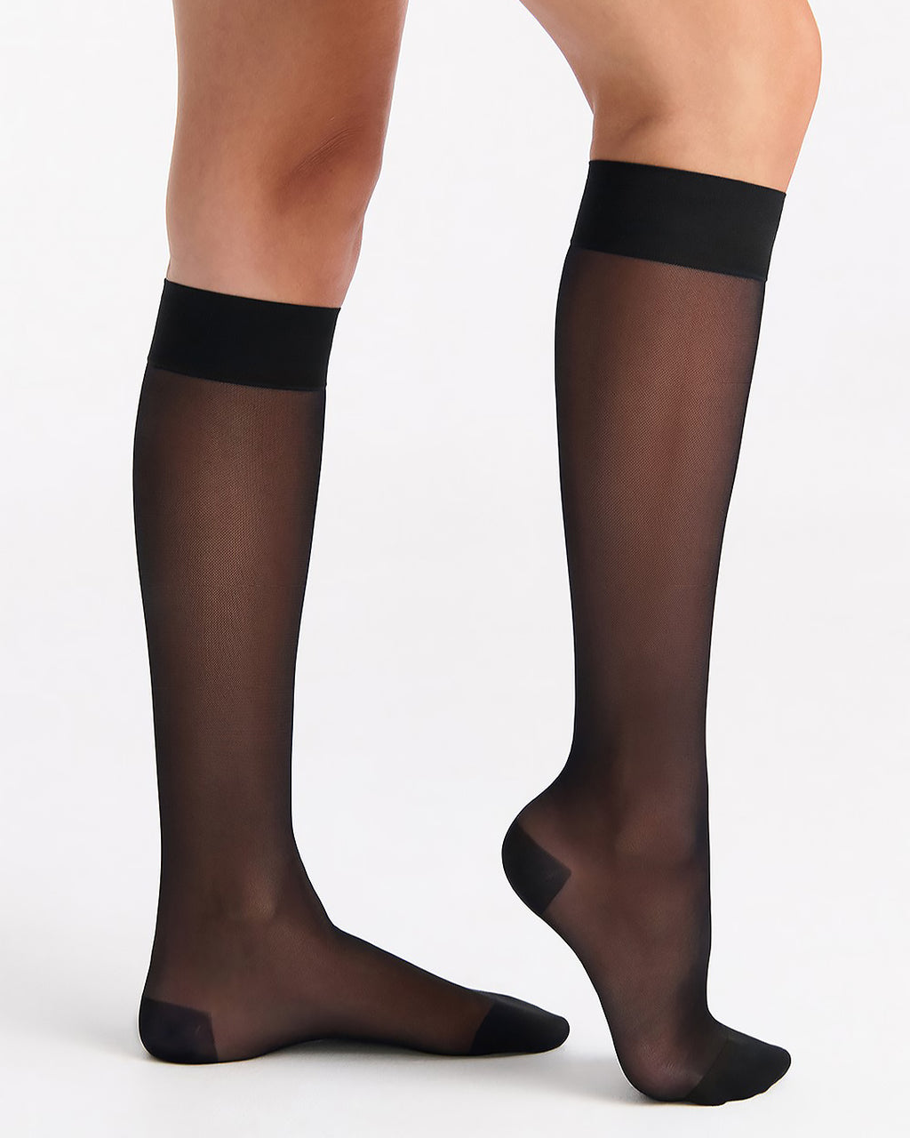 Black sheer stockings worn by a person on a white background